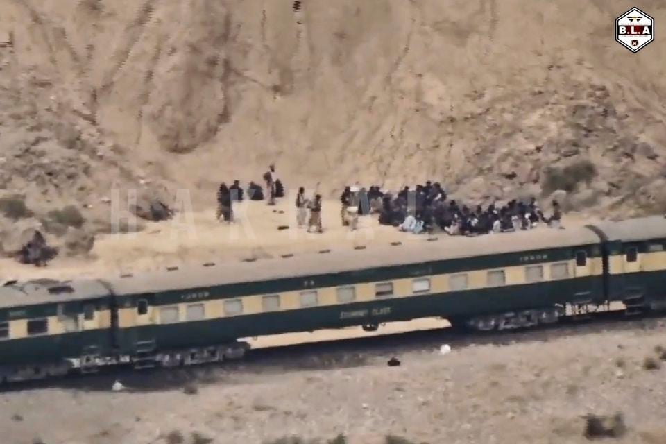 This frame grab from a video released by the Baluchistan Liberation Army shows people outside the train after it was attacked by the BLA (BLA via AP)