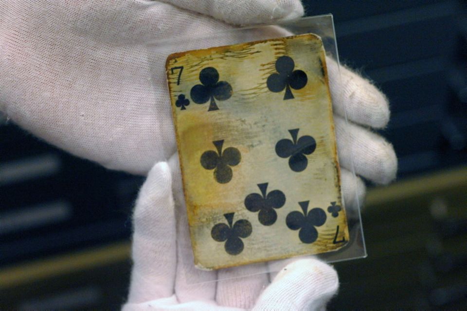 A seven of clubs card is shown as part of the artifacts collection at a warehouse in Atlanta, Friday, Aug 15, 2008. The 5,500-piece collection contains almost everything recovered from the wreckage of the RMS Titanic, which has sat 2.5 miles below the surface of the Atlantic ocean since the boat sank on April 15, 1912.