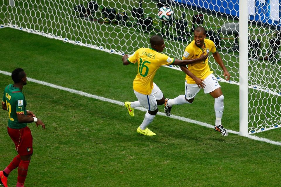 BRASILIA, BRAZIL - JUNE 23:  Fernandinho of Brazil (R) celebrates scoring his team's fourth goal with Ramires as Henri Bedimo of Cameroon looks on during the 2014 FIFA World Cup Brazil Group A match between Cameroon and Brazil at Estadio Nacional on June 23, 2014 in Brasilia, Brazil.  (Photo by Phil Walter/Getty Images)