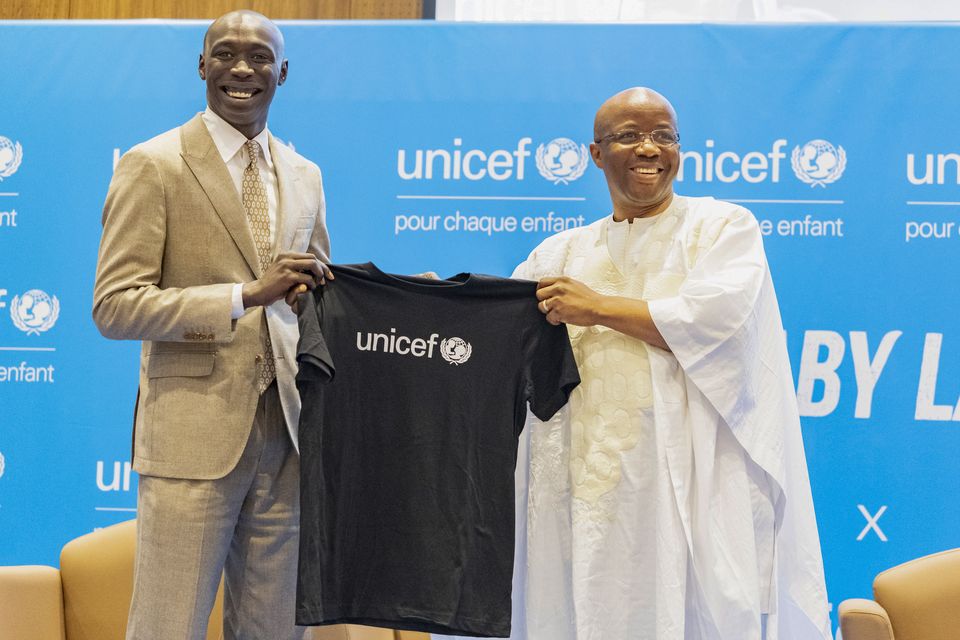 TikTok star Khaby Lame receives a T-shirt from Unicef regional director for West and Central Africa Gilles Fagninou in Dakar, Senegal (Sylvain Cherkaoui/AP)