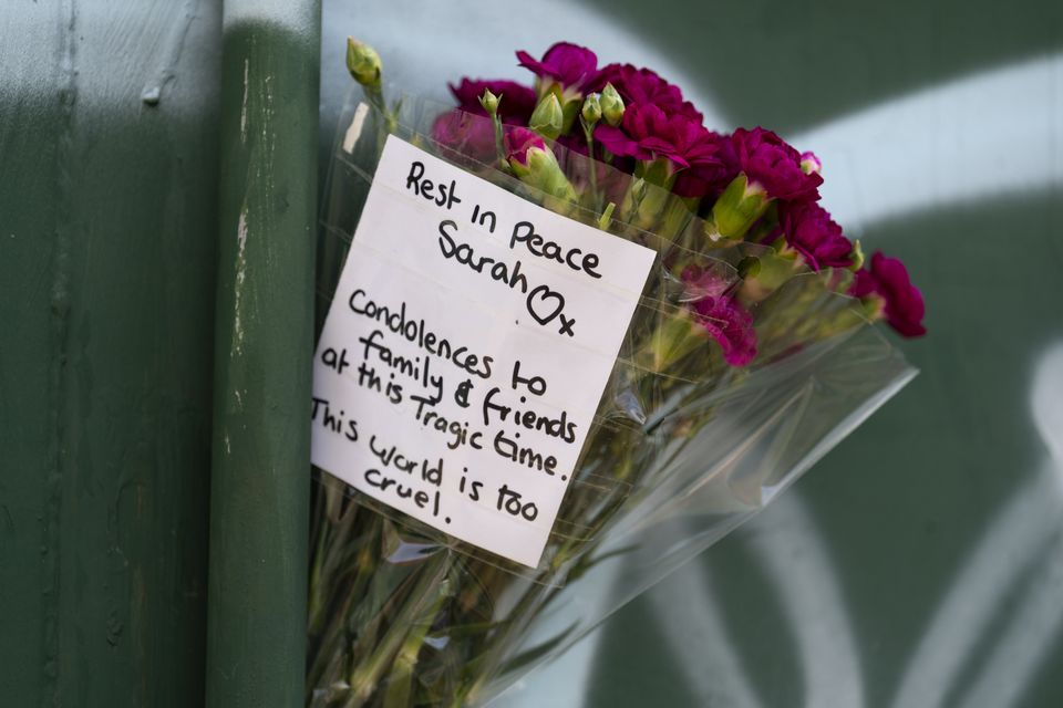 Floral tributes at the scene in Rowdown Fields, in New Addington, south London, where remains belonging to Sarah Mayhew, 38, were found (Jordan Pettitt/PA)