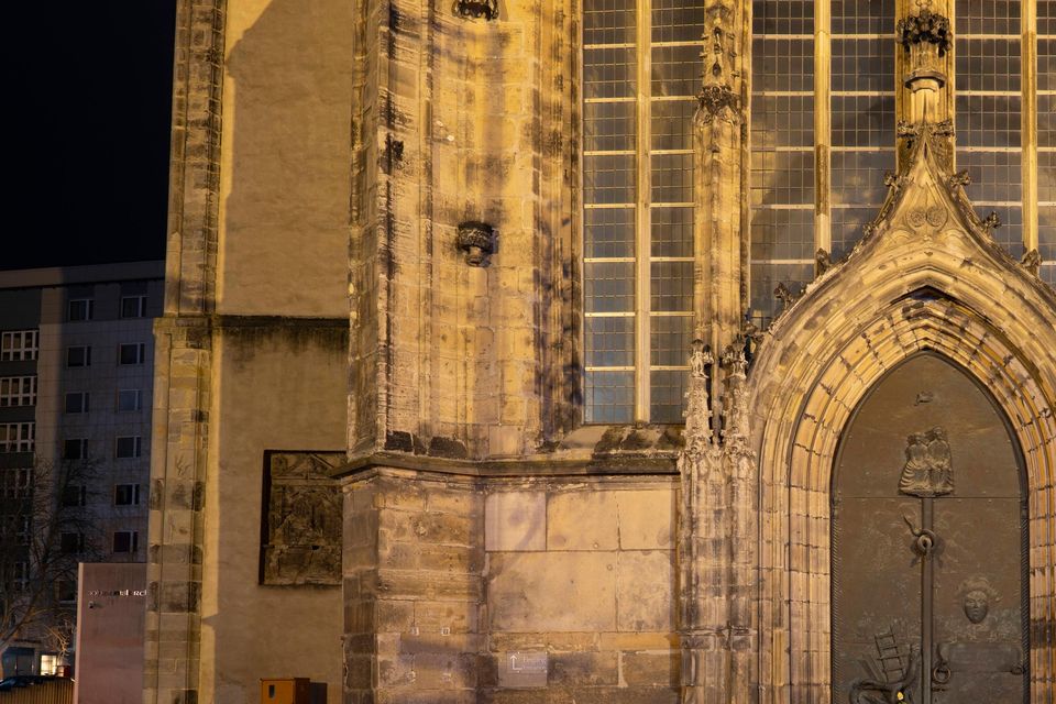 A mass of flowers left in tribute outside St John’s Church in Magdeburg (Sebastian Kahnert/dpa/AP)