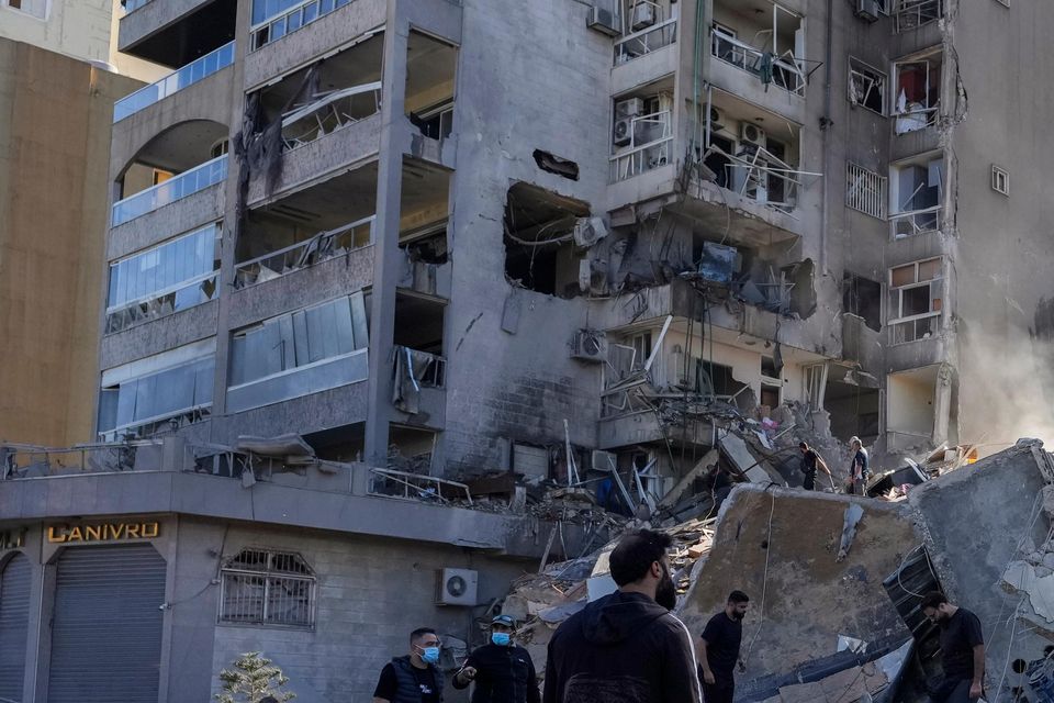 Residents check the site of an Israeli airstrike in Tayouneh, Beirut (Hassan Ammar/AP)