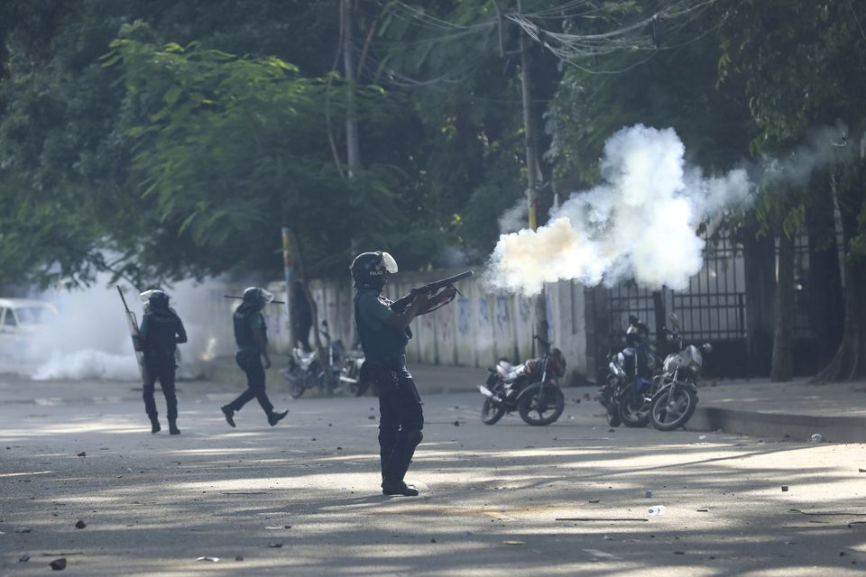 Police fired tear gas shells and rubber bullets to disperse students at the university campus in Dhaka (Rajib Dhar/AP)