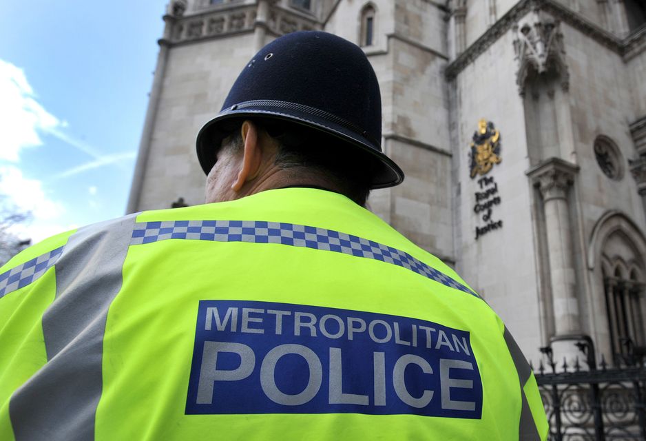 A Metropolitan Police Service (MPS) officer outside the Royal Courts of Justice in central London (Nick Ansell/PA)