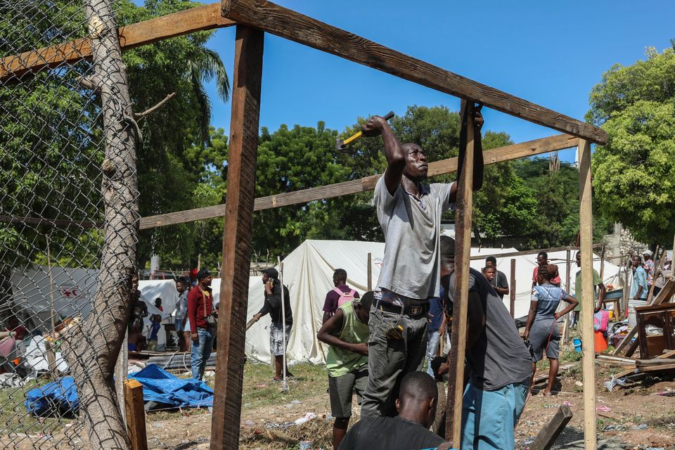 Residents of the Nazon neighbourhood displaced by gang violence construct a tent encampment in Port-au-Prince, Haiti (Odelyn Joseph/AP)