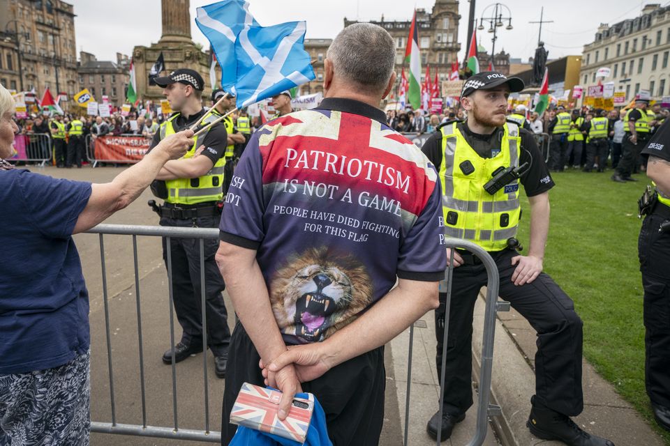 Supporters of a Pro-UK rally endorsed by Tommy Robinson gather in Glasgow’s George Square with a counter-protest organised by Stand Up to Racism (Jane Barlow/PA)