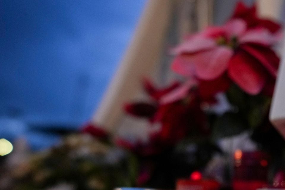 Candles, one showing a photo of Pope Francis, in front of the Agostino Gemelli Polyclinic in Rome (Andrew Medichini/AP)