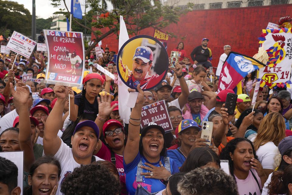 Supporters of Venezuelan President Nicolas Maduro attend a campaign rally in the Catia neighbourhood of Caracas (Matias Delacroix/AP)