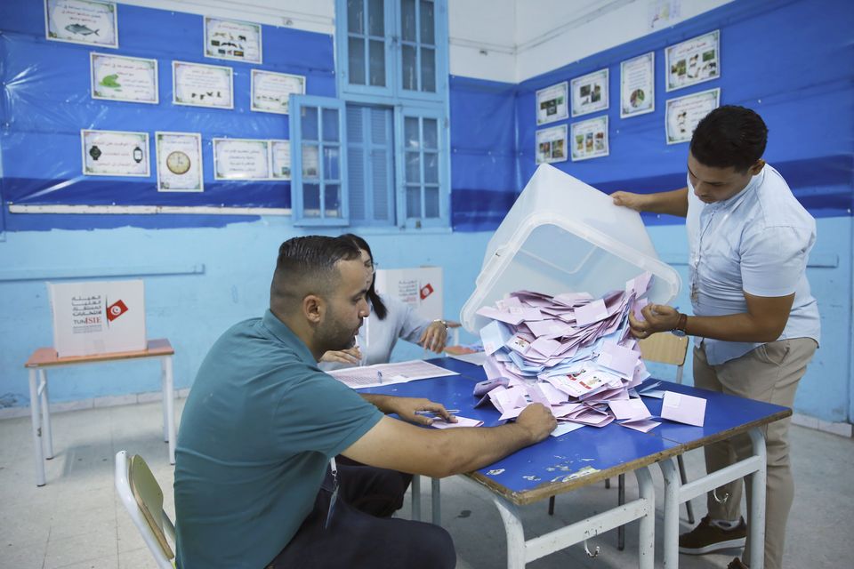 Election officials open a ballot box to count votes in Tunis (Anis Mili/AP)