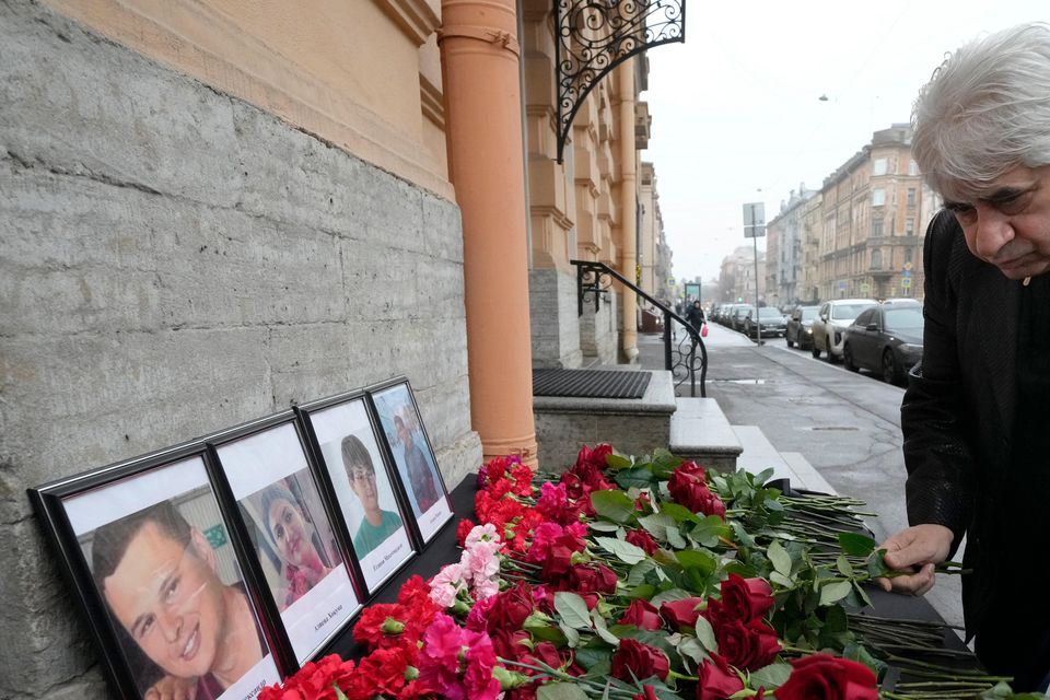 The head of the Azerbaijani diaspora in St Petersburg, Vagif Mamishev, lays flowers at the consulate of Azerbaijan in the city (Dmitri Lovetsky/AP)