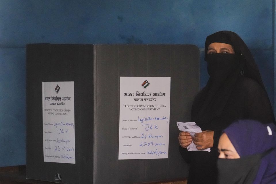 A woman casts her vote in Srinagar, Indian controlled Kashmir (Mukhtar Khan/AP)