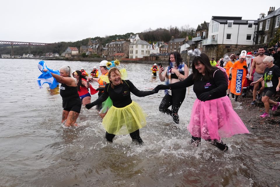 People take the plunge at the Loony Dook New Year’s Day dip (Andrew Milligan/PA)