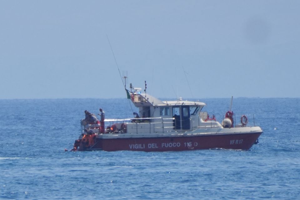 Rescue teams brought the bodies of the victims to shore in Porticello (Jonathan Brady/PA)