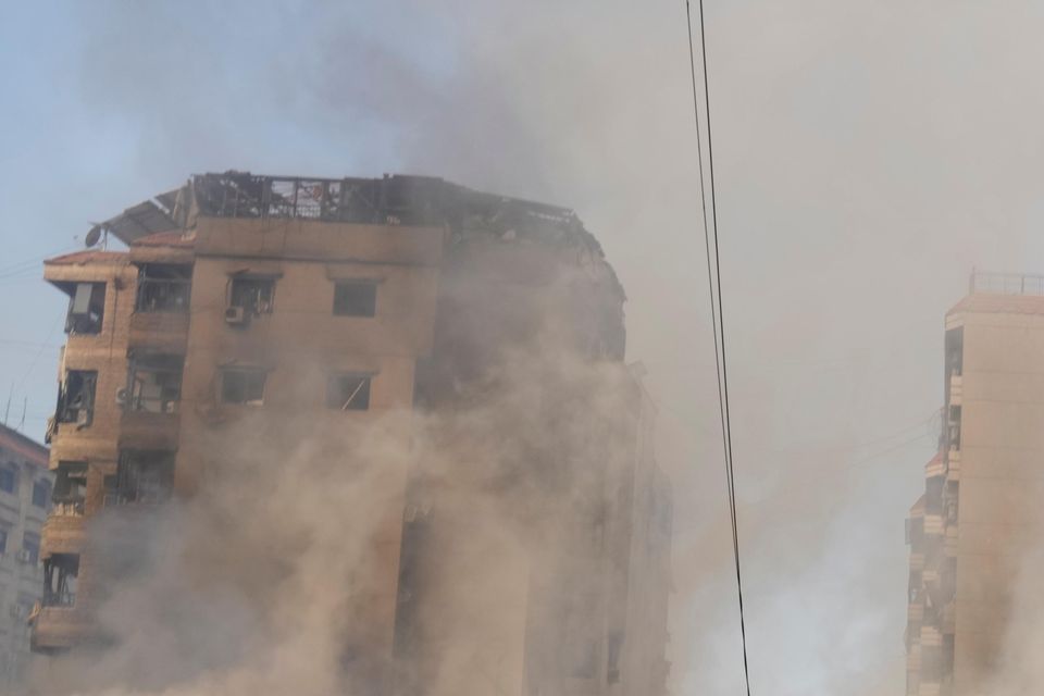 Smoke rises from destroyed buildings in Beirut’s southern suburbs on Saturday morning (Hussein Malla/AP)