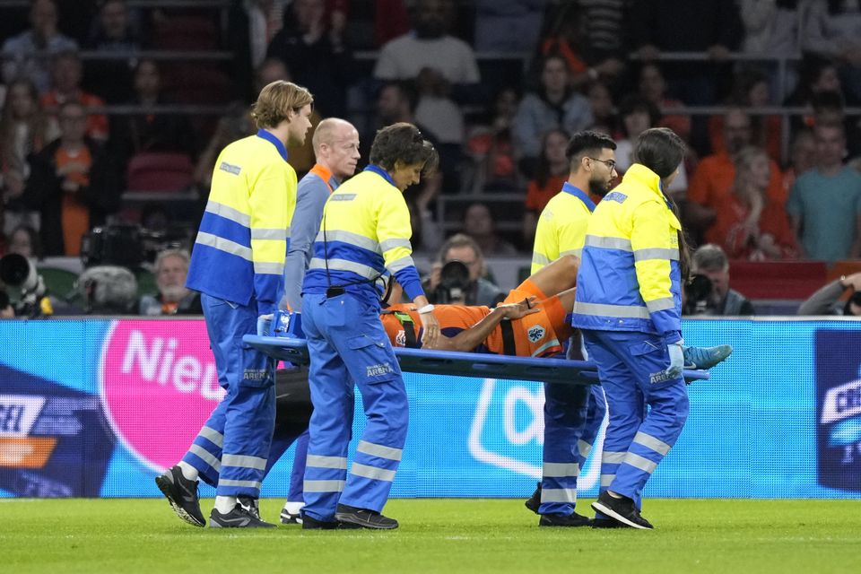 Nathan Ake of the Netherlands is taken off the pitch (Peter Dejong/AP)