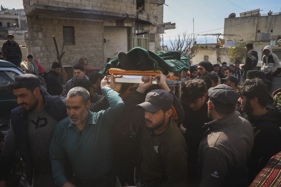 The body of a Syrian security force member is carried for burial in the village of Al-Janoudiya, west of Idlib (Omar Albam/AP)