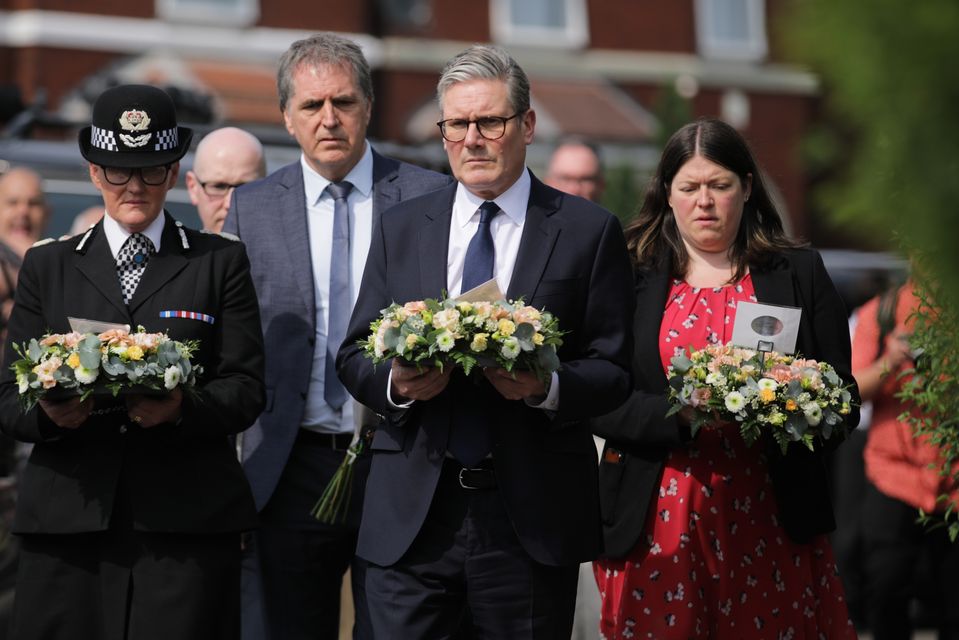 Prime Minister Sir Keir Starmer is seen carrying a floral tribute (James Speakman/PA)