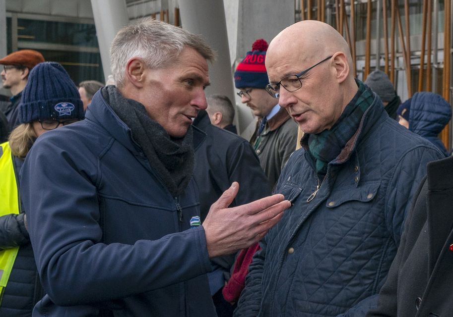 First Minister John Swinney, right, met with Jonnie Hall of NFU Scotland outside Parliament during the rally (Jane Barlow/PA)