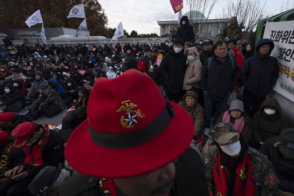 People gather outside the National Assembly during the voting for the impeachment of South Korean President Yoon Suk Yeol (Ng Han Guan/AP)