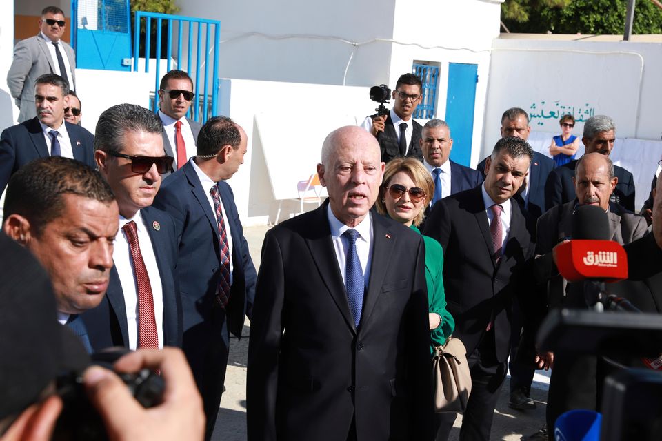 Tunisian president and candidate for re-election Kais Saied attended a polling station in the capital Tunis with his wife (Anis Mili/AP)