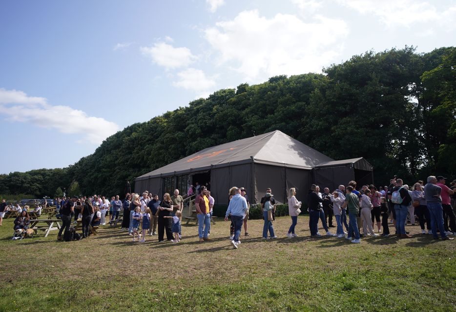 People queuing outside at the opening of Jeremy Clarkson’s new pub, The Farmer’s Dog, in Asthall, near Burford in Oxfordshire in August (Ben Birchall/PA)