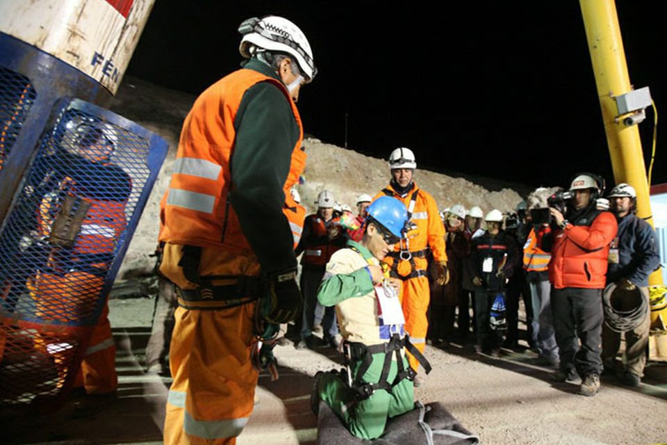 SAN JOSE MINE, CHILE - OCTOBER 13: (NO SALES, NO ARCHIVE) In this handout from the Chilean government, Carlos Mamani, 23, becomes the fourth miner to exit the rescue capsule, on October 13, 2010 at the San Jose mine near Copiapo, Chile. The rescue operation has begun bringing up the 33 miners, 69 days after the August 5, 2010 collapse that trapped them half a mile underground. (Photo by Hugo Infante/Chilean Government via Getty Images)