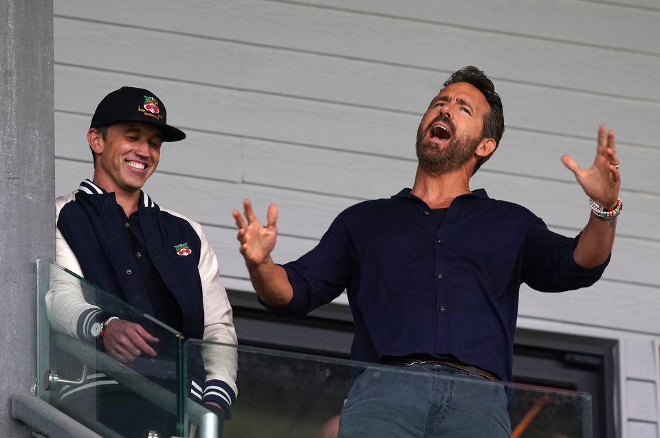 Wrexham co-owners Rob McElhenney (left) and Ryan Reynolds react in the stands (Martin Rickett/PA)