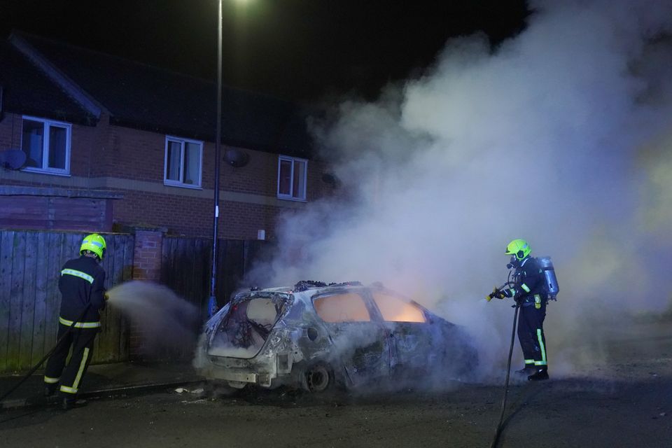 Firefighters tend to a burning police car in Hartlepool (Owen Humphreys/PA)