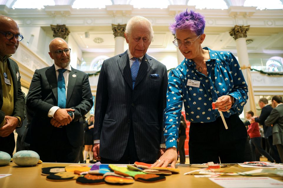 Charles is shown items used in humanitarian responses during a visit to St Peter’s Church in Notting Hill (Mina Kim/PA)