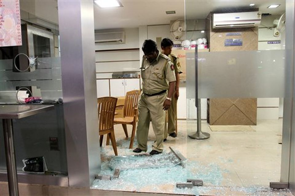 Policemen inspect the site of a gun attack at the Chhatrapati Shivaji Terminus in Mumbai, India, Wednesday, Nov. 26, 2008. Gunmen targeted luxury hotels, a popular tourist attraction and a crowded train station in at least seven attacks in India's financial capital, killing 16 people and wounding 90, officials and media reports said. A.N. Roy, a senior police officer, said police continued to battle the gunmen.   (AP Photo)