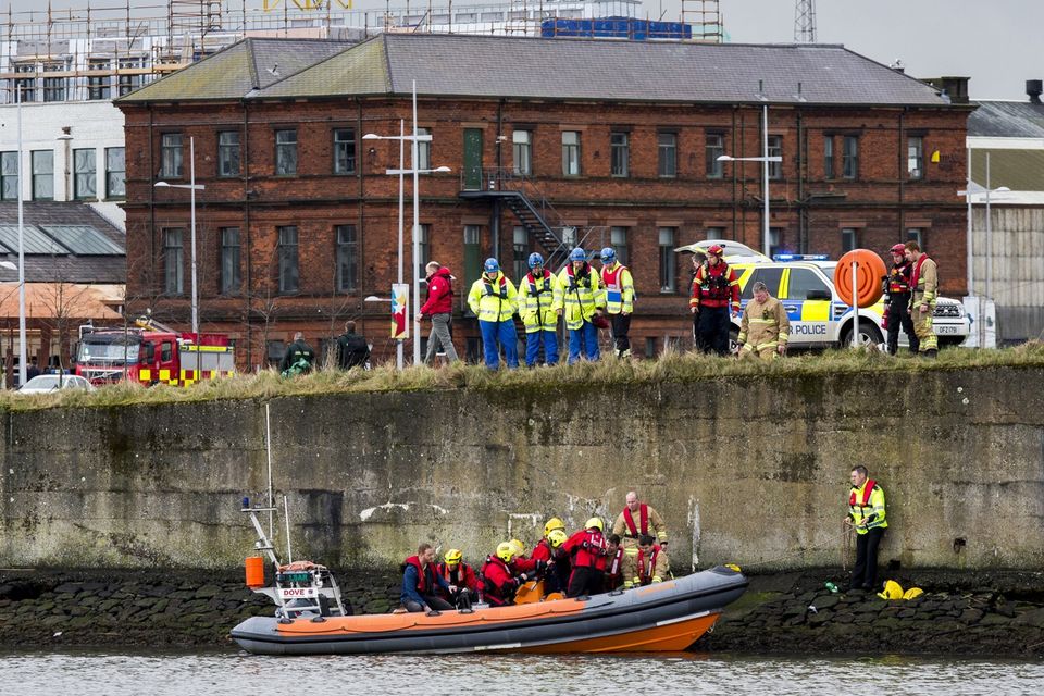 Emergency teams help rescue the woman on the banks of the River Lagan. Pic Liam McBurney/RAZORPIX