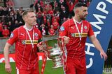 thumbnail: Cliftonville legends Chris Curran and Joe Gormley hold the Irish Cup after the victory over Linfield