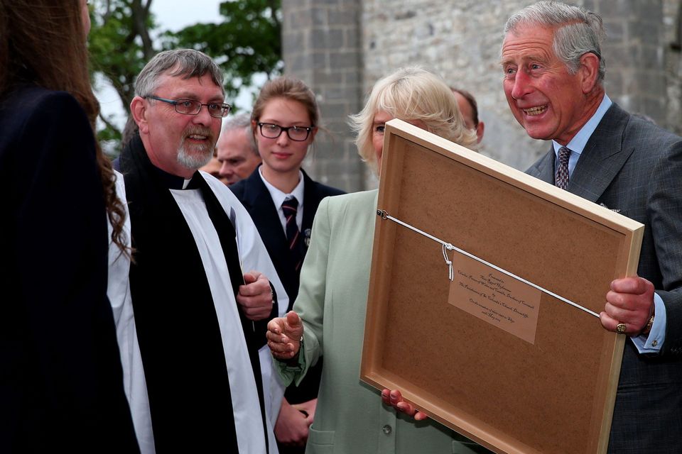 The Prince of Wales and the Duchess of Cornwall receive a painting after a service of peace and reconciliation at St. Columba's Church in Drumcliffe on the second day of a four day visit to Ireland. PRESS ASSOCIATION Photo. Picture date: Wednesday May 20, 2015. See PA story ROYAL Ireland. Photo credit should read: Brian Lawless/PA Wire