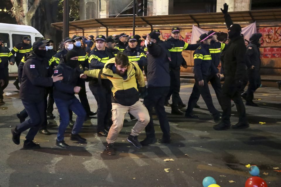 Police detain a protester during a rally against the results of the parliamentary elections amid allegations that the vote was rigged in Tbilisi (Zurab Tsertsvadze/AP)