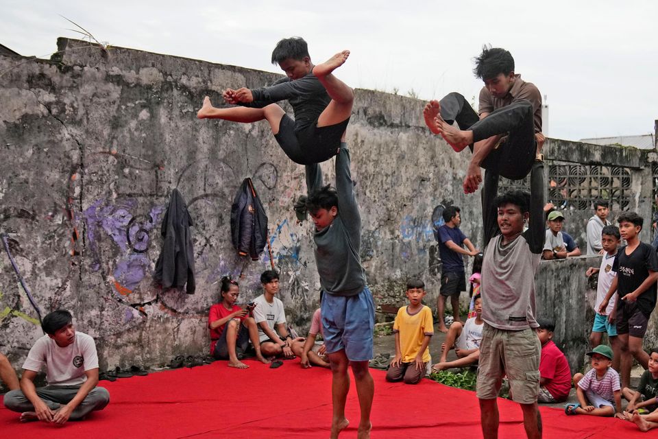 Performance troupes – which can number anywhere from 50 to 100 people – practise for weeks ahead of the celebrations (Dita Alangkara/AP)