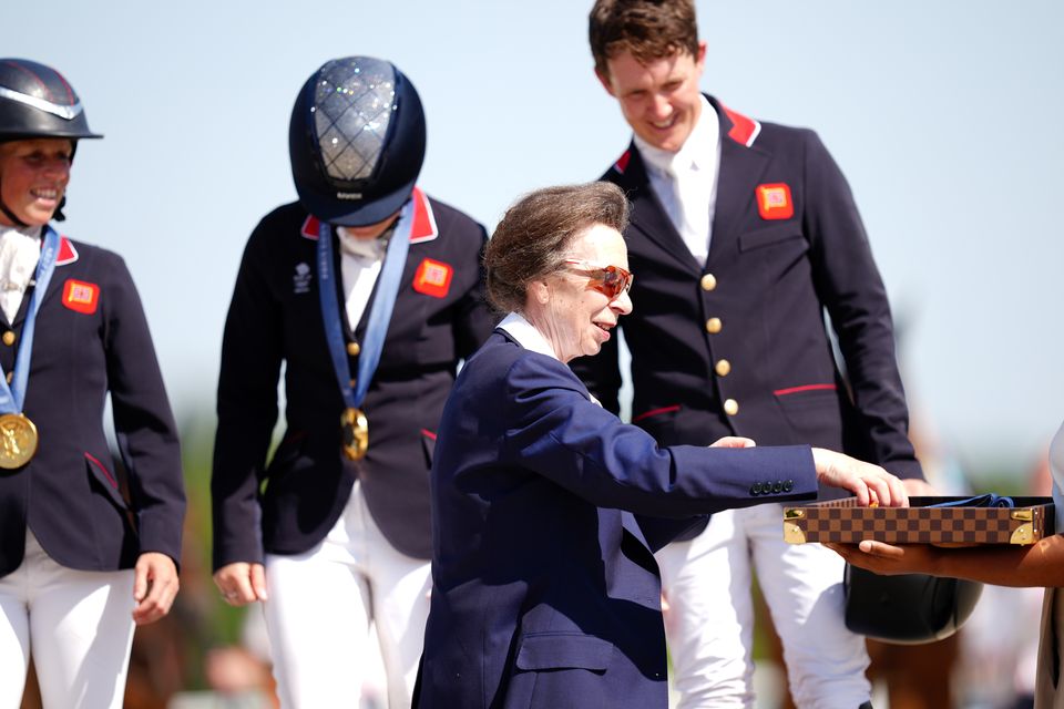 Anne presenting gold medals to Great Britain’s Rosalind Canter, Laura Collett and Tom McEwen following the Eventing Team Jumping Final at the Olympics (David Davies/PA)