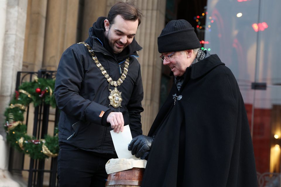 Lord Mayor of Belfast Micky Murray makes a donation as Dean of Belfast, The Very Rev Stephen Forde, begins his Black Santa sit-out at St Anne's Cathedral. Pic: Presseye