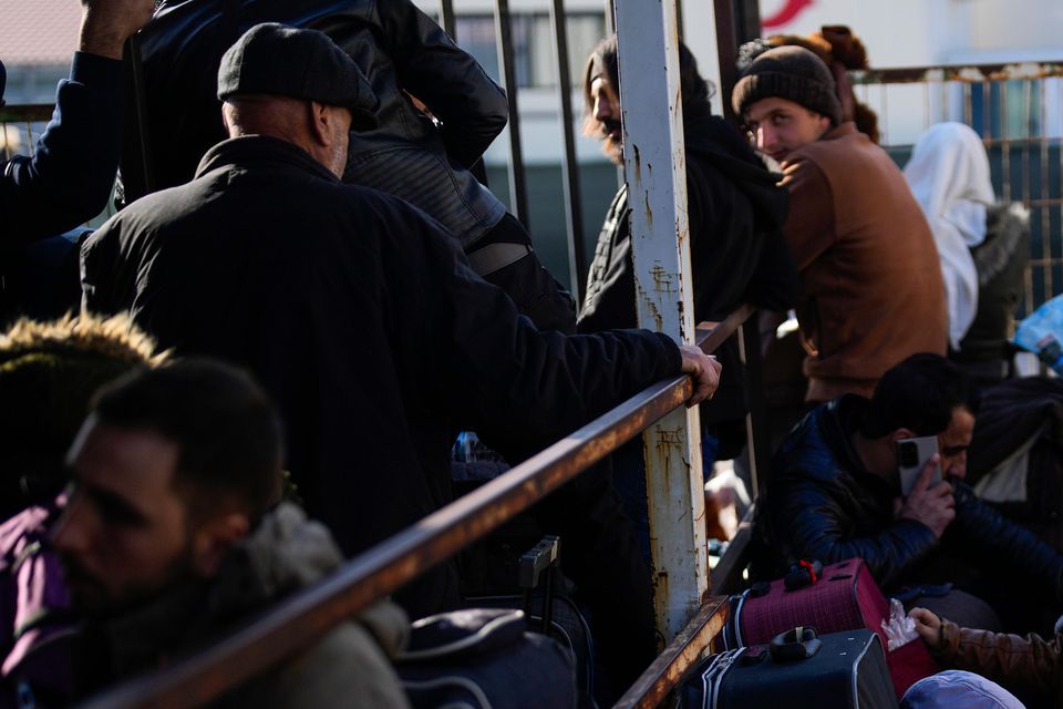 Syrians wait to cross into Syria from Turkey at the Oncupinar border gate, near the town of Kilis, southern Turkey (Khalil Hamra/AP)