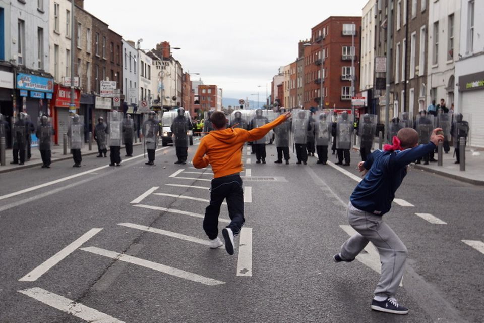 Protesters throw missiles at Irish police in the streets adjacent to the Garden on Remembrance where Queen Elizabeth II laid a wreath on May 17, 2011 in Dublin, Ireland.