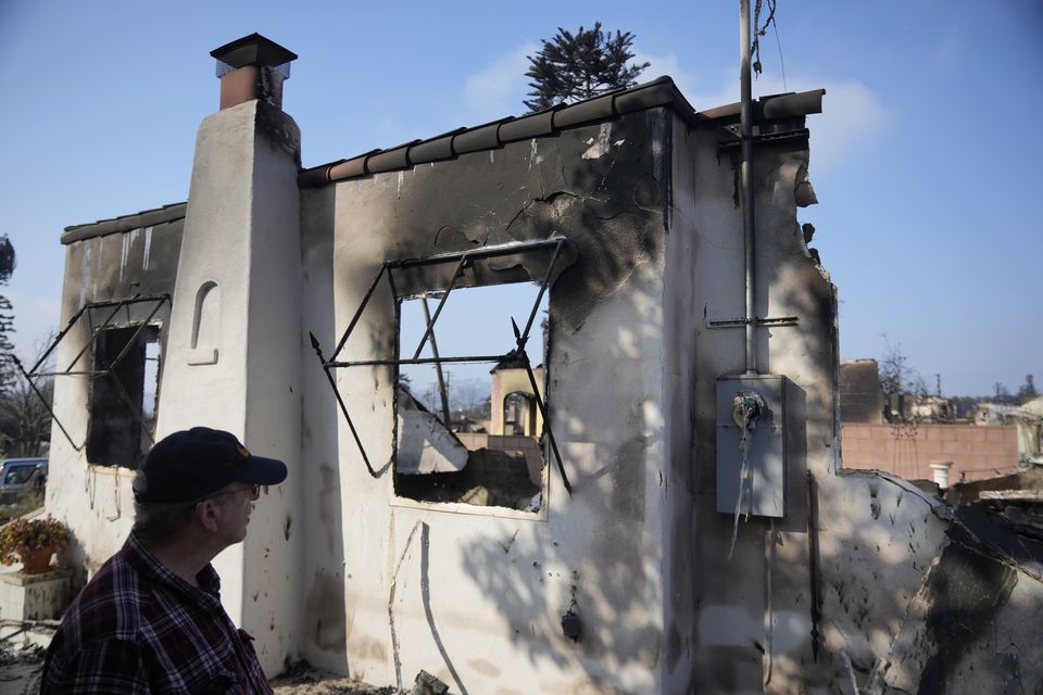 Joel Parkes, a teacher at Los Angeles Unified School District returns to his destroyed home in the aftermath of the Eaton Fire (AP/Damian Dovarganes)