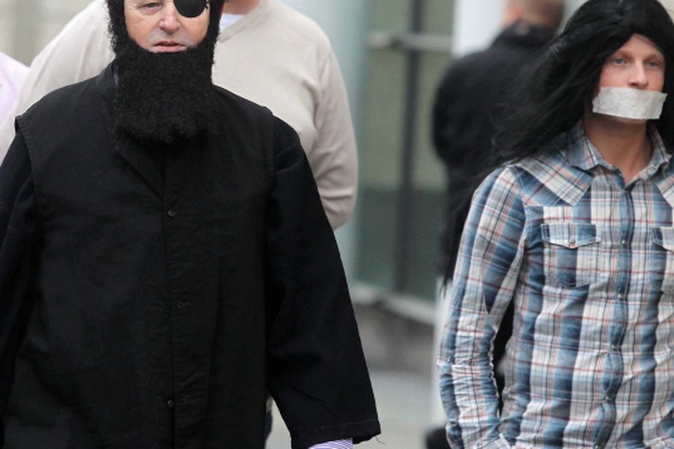 Loyalist campaigner Willie Frazer appears at Belfast Laganiside Courts in relation to his flag protest charges dressed as Muslim Cleric Abu Hamza.  Willie Frazer arrives at court with his supporters including Jamie Bryson (right)