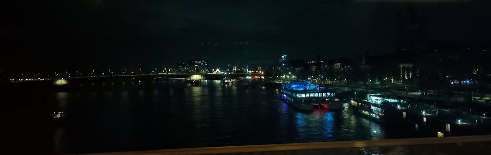 The lights of Cologne reflected in the Rhine during a brief night-time stop