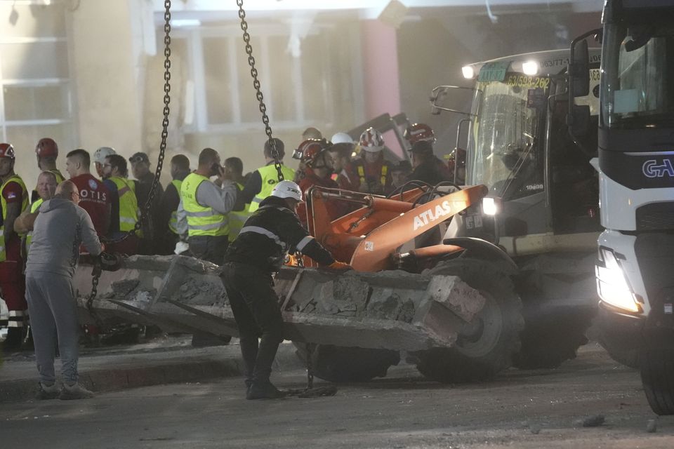 Rescue workers search for victims after the roof collapse at Novi Sad station (Darko Vojinovic/AP)