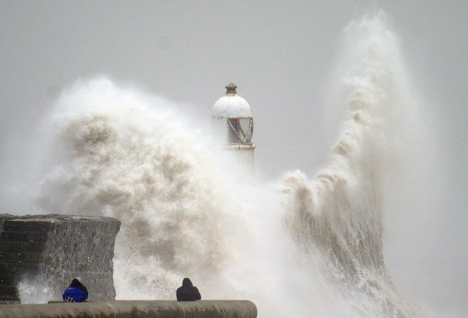 Huge waves crash over the seafront in Porthcawl, south Wales, during Storm Darragh in December (Ben Birchall/PA)