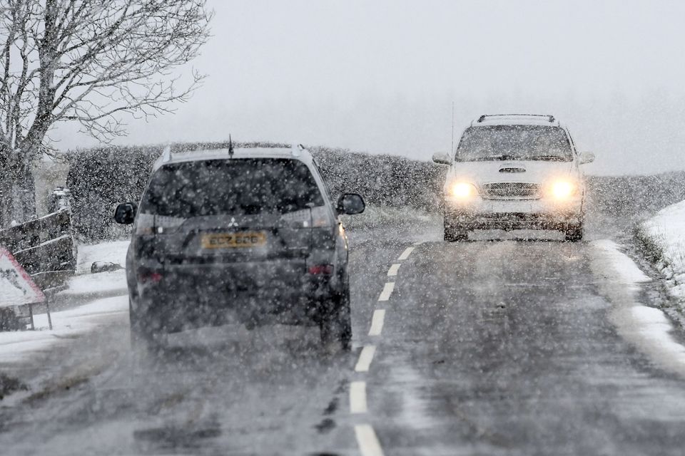 Drivers battle through the snow on the outskirts of Armoy in Northern Ireland. Photo Colm Lenaghan/Pacemaker Press