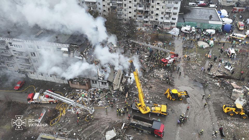 Firefighters put out a fire in a apartment building following a Russian rocket attack in Poltava, Ukraine, on Saturday (Ukrainian Emergency Service via AP)