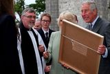 thumbnail: The Prince of Wales and the Duchess of Cornwall receive a painting after a service of peace and reconciliation at St. Columba's Church in Drumcliffe on the second day of a four day visit to Ireland. PRESS ASSOCIATION Photo. Picture date: Wednesday May 20, 2015. See PA story ROYAL Ireland. Photo credit should read: Brian Lawless/PA Wire