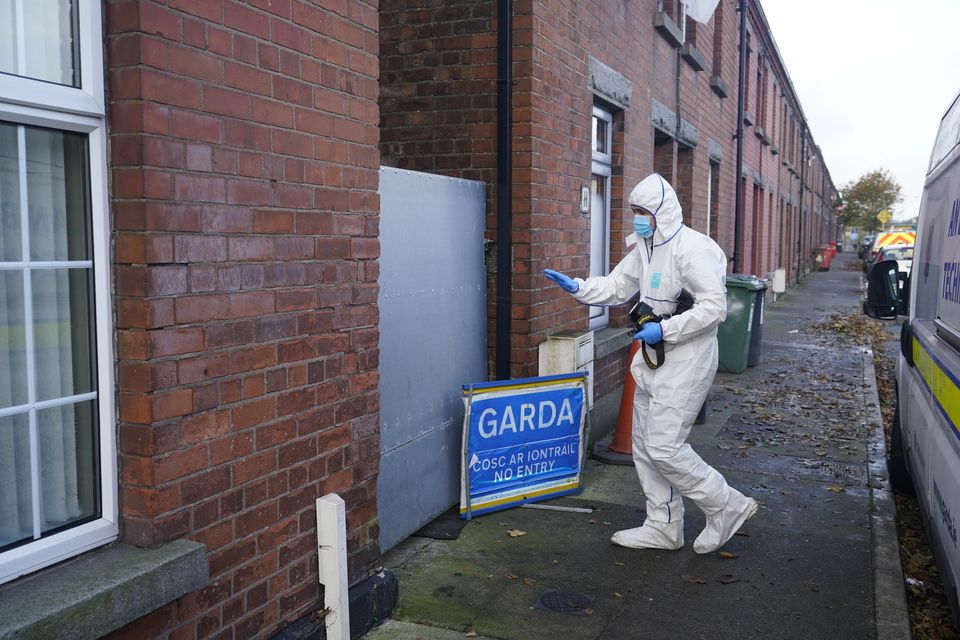 A gardai forensic officer in Dundalk, Co Louth, as they search a house in the investigation into the suspected murder of Kyran Durnin (Niall Carson/PA)