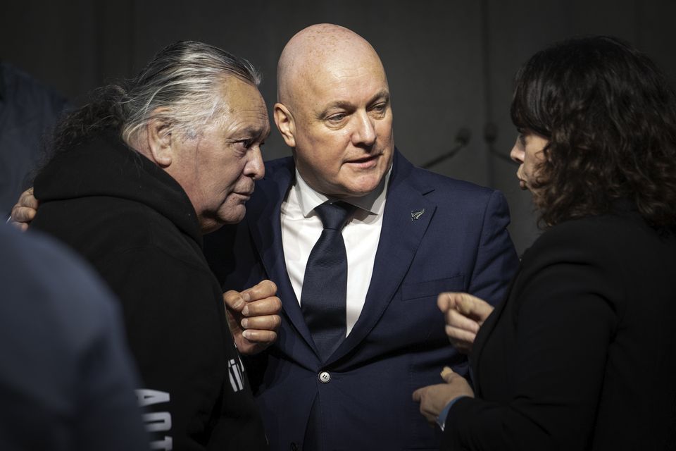 New Zealand’s Prime Minister Christopher Luxon talks to survivor Whiti Ronaki, left, and Laura Cherrington (Monique Ford/Stuff via AP)